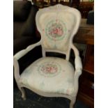 A CREAM PAINTED SHOW FRAME ARMCHAIR, THE UPHOLSTERY WITH WREATHED FLORAL ROUNDELS