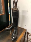 A PAIR OF BLACK LEATHER RIDING BOOTS.