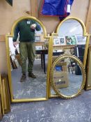 A PAIR OF SHAPED GILT FRAME DECORATIVE MIRRORS. 115 x 54cms. TOGETHER WITH AN OVAL BEVEL EDGE MIRROR