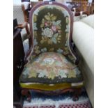 A VICTORIAN MAHOGANY SHOW FRAME HOOP BACKED CHAIR UPHOLSTERED IN FLORAL NEEDLEWORK. THE CABRIOLE