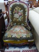 A VICTORIAN MAHOGANY SHOW FRAME HOOP BACKED CHAIR UPHOLSTERED IN FLORAL NEEDLEWORK. THE CABRIOLE