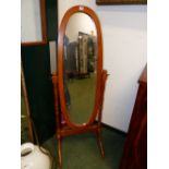 A MODERN OVAL FULL LENGTH DRESSING MIRROR ON CHEVAL STAND