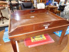 A 19th C. MAHOGANY BUTLERS TRAY LATER MOUNTED ON TAPERING SQUARE LEGS AS A COFFEE TABLE