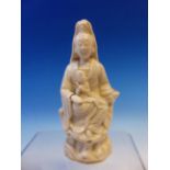 A BLANC DE CHINE FIGURE OF GUANYIN WITH A CHILD ON HER LAP. H 15.5cms.