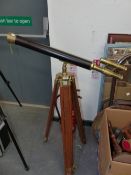 A LEATHER BOUND BRASS TELESCOPE ON TEAK STAND.