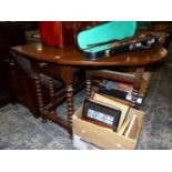 AN OAK OVAL DROP FLAP TABLE WITH DRAWERS TO EACH END ABOVE BOBBIN TURNED LEGS JOINED BY