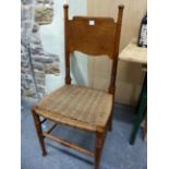 A PAIR OF WILLIAM BIRCH ARTS AND CRAFTS OAK DINING CHAIRS WITH SHAPED BROAD BACK RESTS ABOVE RUSH