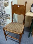 A PAIR OF WILLIAM BIRCH ARTS AND CRAFTS OAK DINING CHAIRS WITH SHAPED BROAD BACK RESTS ABOVE RUSH