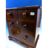 A 19th C. MAHOGANY MINIATURE CHEST OF TWO SHORT AND TWO GRADED LONG DRAWERS ON SHAPED BRACKET