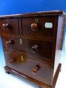 A 19th C. MAHOGANY MINIATURE CHEST OF TWO SHORT AND TWO GRADED LONG DRAWERS ON SHAPED BRACKET