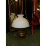 A VINTAGE HANGING OIL LAMP WITH GLASS SHADE.