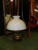 A VINTAGE HANGING OIL LAMP WITH GLASS SHADE.