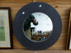 A FIRED EARTH SLATE FRAME CIRCULAR MIRROR. D. 60cms