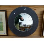 A FIRED EARTH SLATE FRAME CIRCULAR MIRROR. D. 60cms