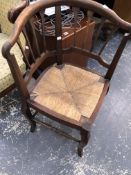 A 19th C. OAK CORNER DESK CHAIR WITH RUSH SEAT TOGETHER WITH A MAHOGANY DESK CHAIR WITH CURVED