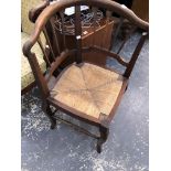A 19th C. OAK CORNER DESK CHAIR WITH RUSH SEAT TOGETHER WITH A MAHOGANY DESK CHAIR WITH CURVED