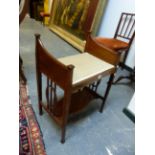 AN ART NOUVEAU LINE INLAID MAHOGANY STOOL, THE SEAT FLANKED BY CURVED BOARD ARMS ABOVE OVAL CENTRED