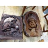 TWO CARVED HARDWOOD WALL PLAQUES.