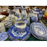 A COLLECTION OF 19th C. AND OTHER BLUE AND WHITE WASH JUGS, PLATES, PLATTERS, AND LARGE MUGS.