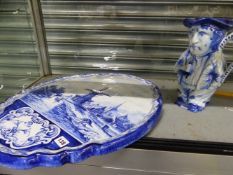 A LARGE DELFT BLUE AND WHITE WALL PLAQUE AND A DOUBLE TOBY JUG.