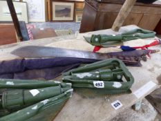 A MILITARY TYPE MACHETE, THREE TRENCHING SPADES AND TWO SMALL FLAGS.