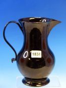 A LATE 18th/EARLY 19th C. JACKFIELD GLAZED JUG. H 21.5cms.