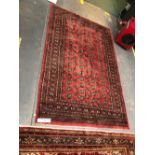 AN ORIENTAL RUG OF BOKHARA DESIGN. 244 x 155cms