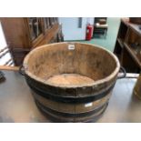 A TWO HANDLED IRON COOPERED TUB. Dia. 38cms. CONTAINING BRASS WARE, A PAIR OF CHILDS LEATHER BOOTS