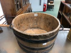 A TWO HANDLED IRON COOPERED TUB. Dia. 38cms. CONTAINING BRASS WARE, A PAIR OF CHILDS LEATHER BOOTS