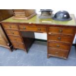 A 20th C. MAHOGANY PEDESTAL DESK WITH GREEN LEATHER INSET TOP ABOVE A KNEEHOLE DRAWER FLANKED BY