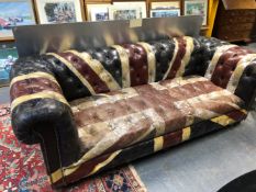 A BUTTON BACKED LEATHER CHESTERFIELD PAINTED WITH THE UNION FLAG AND ON CASTER FEET. W 214cms.