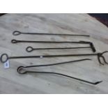 A COLLECTION OF FIVE IRON FIRE TOOLS, EACH WITH LOOP HANDLES