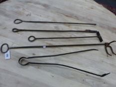 A COLLECTION OF FIVE IRON FIRE TOOLS, EACH WITH LOOP HANDLES