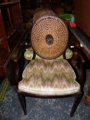 A PAIR OF REGENCY STYLE MAHOGANY ELBOW CHAIRS WITH CANED OVAL BACKS AND SEATS ON SQUARE SECTIONED