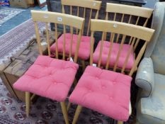 A SET OF FOUR 20th C. BEECH KITCHEN CHAIRS, BROAD TOP RAILS OVER THE STICK BACKS, SOLID SEATS AND