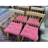 A SET OF FOUR 20th C. BEECH KITCHEN CHAIRS, BROAD TOP RAILS OVER THE STICK BACKS, SOLID SEATS AND