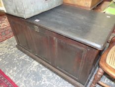 A 20th C. BLACKENED OAK COFFER WITH THREE PANEL FRONT. W 98 x D 49 x H 55cms.