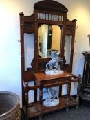 A LATE VICTORIAN MAHOGANY MIRROR BACKED HALL STAND,THE BACK WITH AN ARRANGEMENT OF BRASS COAT HOOKS