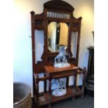 A LATE VICTORIAN MAHOGANY MIRROR BACKED HALL STAND,THE BACK WITH AN ARRANGEMENT OF BRASS COAT HOOKS