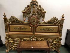 GILT AND COLOURED DOUBLE BED HEAD AND FOOTBOARD BOTH DECORATED WITH FLOWERS AND FOLIAGE, THE HEAD