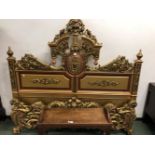 GILT AND COLOURED DOUBLE BED HEAD AND FOOTBOARD BOTH DECORATED WITH FLOWERS AND FOLIAGE, THE HEAD