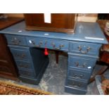 A BLUE PAINTED PEDESTAL DESK, THE KNEEHOLE DRAWER FLANKED BY BANKS OF FOUR DRAWERS ON PLINTH FEET. W