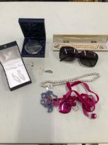 A RALPH LAUREN BEADED NECKLACE, A PAIR OF POLAROID SUNGLASSES, A NIKE PENDANT, A FAUX PEARL