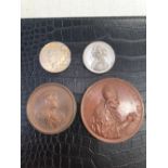 TWO LARGE BRONZED MEDALLIONS, A 1934 SILVER DOLLAR, AND A VICTORIA MEDALLION.