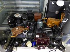 A LARGE COLLECTION OF VARIOUS BINOCULARS, CAMERAS AND LENSES, TRIPODS ETC.