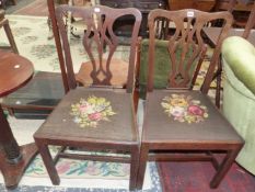 A PAIR OF 19th C. OAK CHIPPENDALE TASTE DINING CHAIRS WITH FLORAL NEEDLE WORK DROP IN SEATS ABOVE