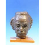 A BRONZE PORTRAIT OF EINSTEIN MOUNTED ON AN OAK PLINTH AND SIGNED M SANDERS ADAMS. H 20cms.