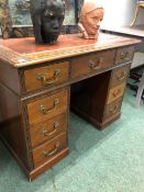 A LATE 19th C. MAHOGANY PEDESTAL DESK WITH A BLIND FRET BAND ENCLOSING THE RED LEATHER INSET TOP,