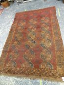 AN ANTIQUE AFGHAN BOKHARA CARPET 386x261cms