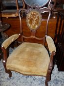 A VICTORIAN MAHOGANY ARM CHAIR, A BUTTONED OVAL BELOW THE SEPENTINE TOP RAIL, THE SERPENTINE FRONTED